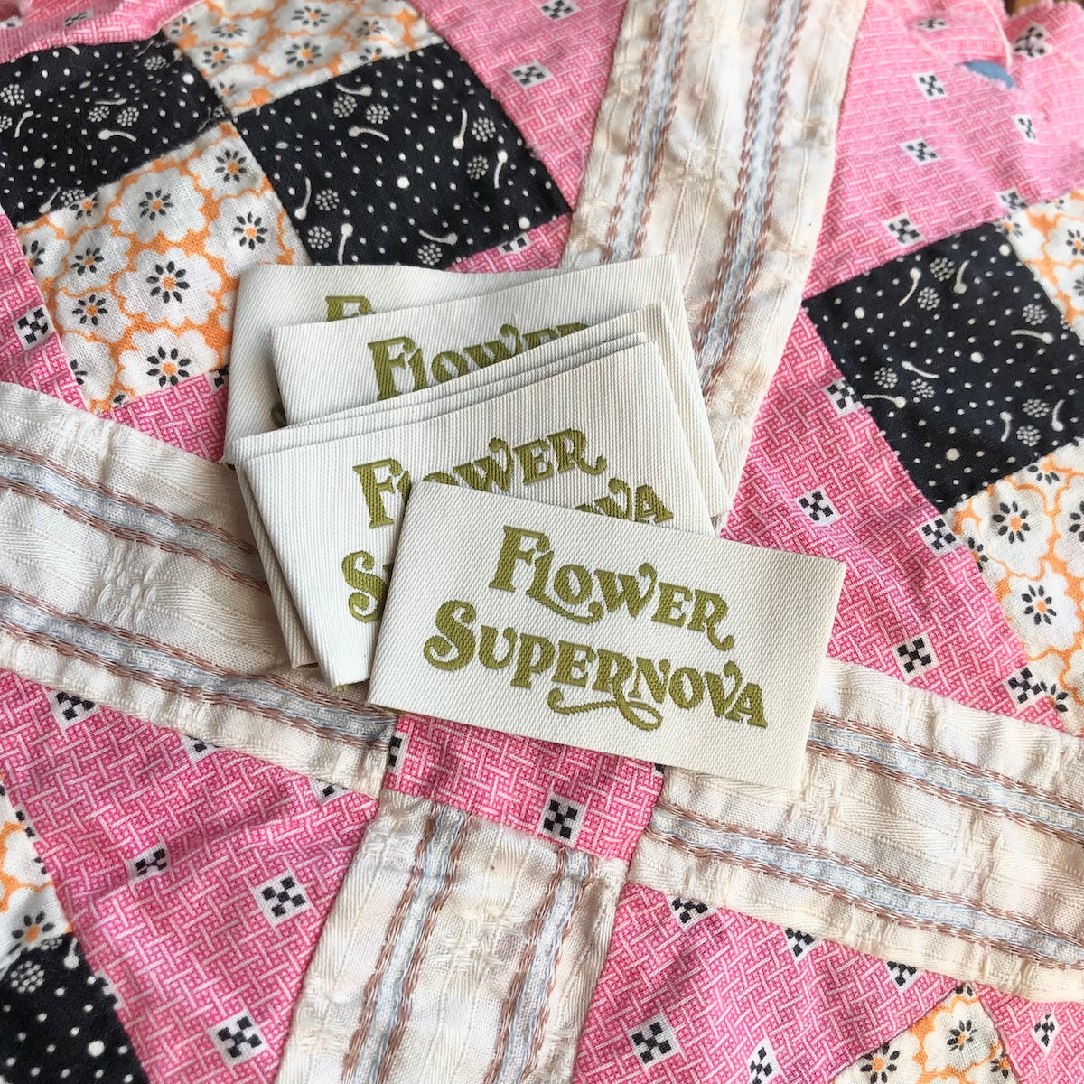 Flower Supernova clothing label on vintage patchwork fabric