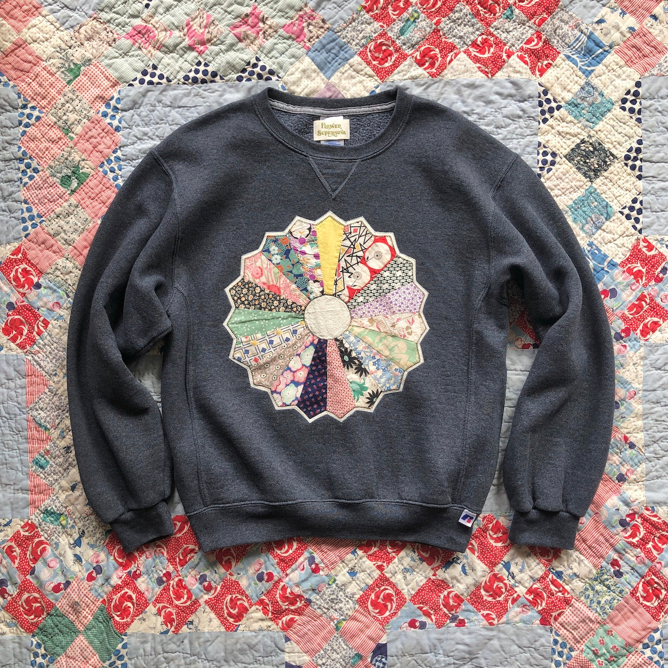 Heather gray crewneck sweatshirt with Dresden Plate vintage quilt patch sewn to front by Flower Supernova.