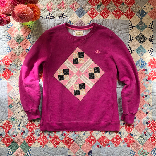 Pink crewneck sweatshirt with vintage quilt patch sewn to front by Flower Supernova.